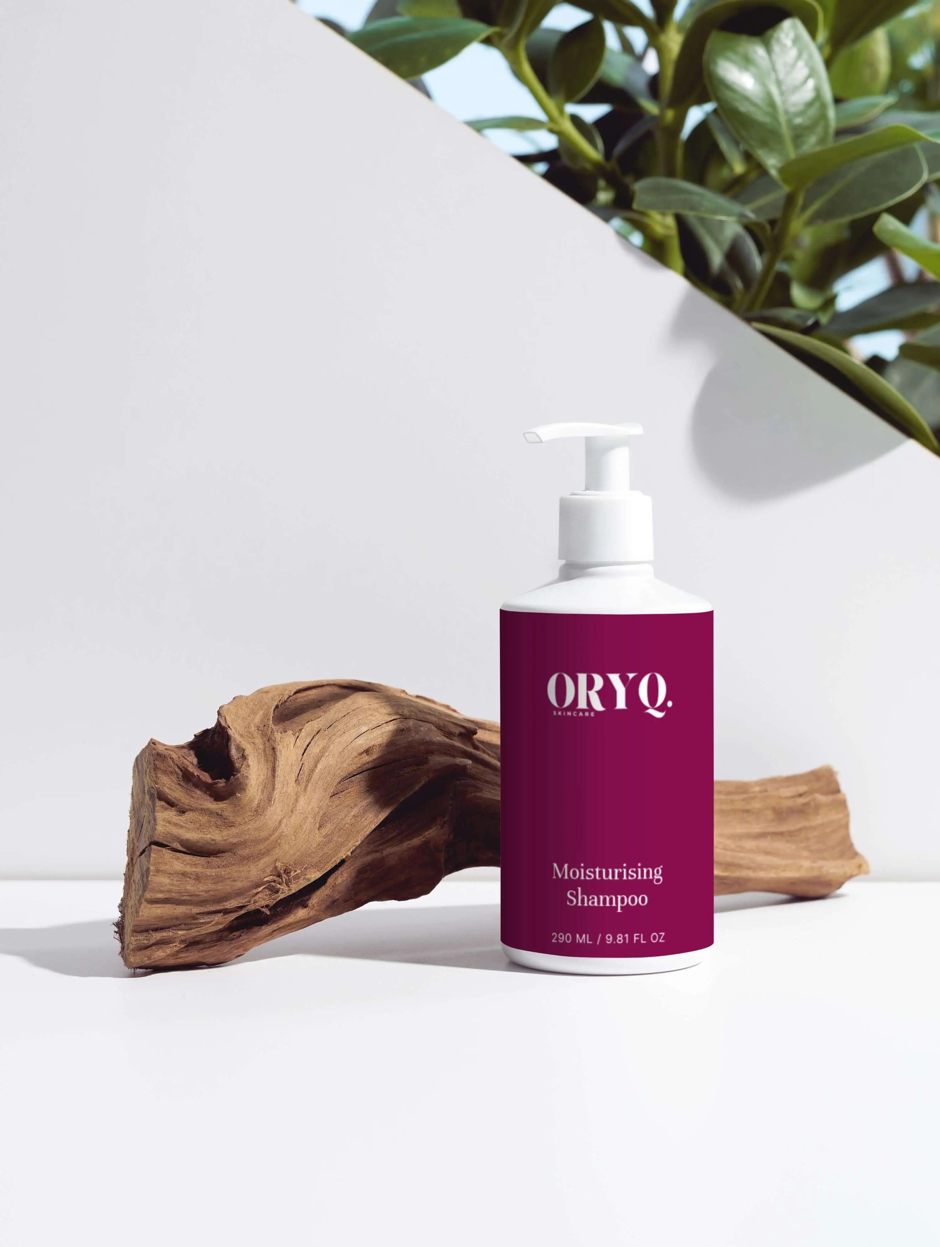 Moisturising Shampoo bottle displayed with natural wood and greenery in the background.